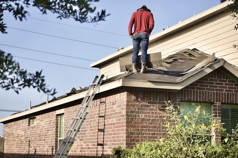 Professional roofer working on a residential roof in James City